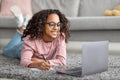 African american girl studying online from home and taking notes, having distance education Royalty Free Stock Photo