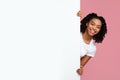 Joyful African American Woman Looking Out Behind Blank Advertisement Board Royalty Free Stock Photo