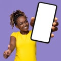 Joyful african american woman showing celll phone and thumb up Royalty Free Stock Photo