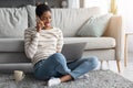 Joyful African American Woman Talking On Cellphone And Using Laptop At Home Royalty Free Stock Photo