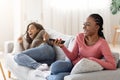 Joyful african girls watching TV at home