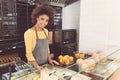 Joyful african young woman laboring in vegetarian shop with pleasure