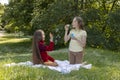 Joyful Asian Caucasian Girls, Children Of Elementary School Age Blow Soap Bubbles In Royalty Free Stock Photo