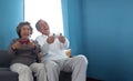 Joyful Asian Senior couple playing games