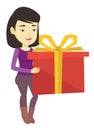 Joyful asian woman holding box with gift.