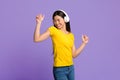 Joyful Asian Woman Listening Music And Dancing With Closed Eyes