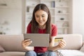 Joyful Asian Woman Using Digital Tablet And Credit Card For Online Shopping Royalty Free Stock Photo