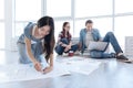 Joyful Asian woman working on a blueprint Royalty Free Stock Photo