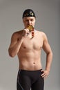 Joyful athlete swimmer kissing the won medal positive emotions, joy of victory, success concept. Royalty Free Stock Photo