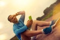 Joyful athlete after training sitting and looking at smartphone Royalty Free Stock Photo