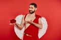 joyful bearded man in cupid costume