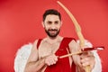 joyful bearded man in cupid costume