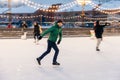 Joyful bearded man practices going skating on ice ring, has cheerful expression, smiles happily, demontrates his professionalism.