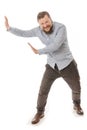 Joyful bearded man in shirt pushing invisible wall