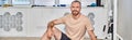 joyful bearded man in sportswear sitting