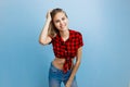 Joyful beautiful young blond girl with blue eyes wearing red checkered shirt and blue jeans, smiling laughing looking at Royalty Free Stock Photo