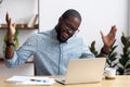 Joyful black businessman talking with friend make video call