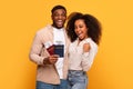 Joyful black couple with passports ready to travel