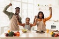 Joyful Black Family Shaking Fists Holding Hands Celebrating In Kitchen Royalty Free Stock Photo