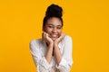 Joyful Black Girl Holding Hands On Cheeks And Smiling At Camera