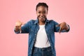 Joyful Black Girl Pointing Fingers Down Posing On Pink Background