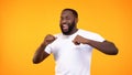 Joyful black male dancing on bright background, achievement happiness, fun