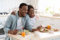 Joyful Black Millennial Couple Using Digital Tablet For Video Call In Kitchen Royalty Free Stock Photo