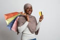 Joyful Black Muslim Shopaholic Woman Posing With Shopping Bags And Credit Card Royalty Free Stock Photo