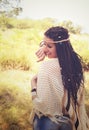 Joyful boho style girl portrait, dressed in knitted poncho and headband have a fun against sunny autumn park, Royalty Free Stock Photo