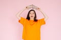 Joyful Book Enthusiasm: Cheerful Woman Holding Book Overhead with Exuberance - Delightful Mood and Positivity Concept Royalty Free Stock Photo