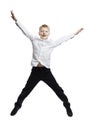 The joyful boy is jumping. The guy in trousers and a white shirt. Activity and movement. Full height. Isolated on white background