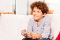 Joyful boy playing console game after school Royalty Free Stock Photo