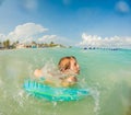 Joyful boy plays in the sea, creating playful splashes and enjoying the waves Royalty Free Stock Photo