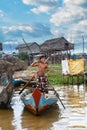 Joyful Boy Rowing Boat on Tonle Sap Lake, Cambodia Royalty Free Stock Photo