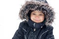 Joyful boy in snowsuit