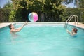 Joyful brothers playing ball in swimming pool Royalty Free Stock Photo