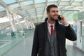 Joyful businessman calling by phone from train station Royalty Free Stock Photo