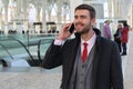 Joyful businessman calling by phone from train station Royalty Free Stock Photo