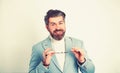 Joyful businessman welcoming and smiling while wearing glasses and a modern blue suit.