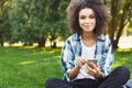 Cheerful young woman using laptop in park Royalty Free Stock Photo