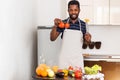 African man preparing healthy food at home in kitchen Royalty Free Stock Photo