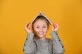 Joyful and cheerful girl holds a book over her head Royalty Free Stock Photo