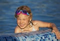 Joyful child at edge of swimming pool