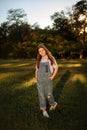 joyful child girl walking in summer park to meet with friends - childhood, leisure and people concept. vertical photo Royalty Free Stock Photo