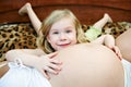 Joyful child about a pregnant mother.