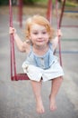 Joyful child swinging on a swing