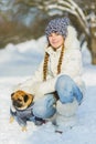 Joyful children playing in snow. Two happy girls having fun outside winter day Royalty Free Stock Photo