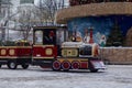 Joyful Christmas atmosphere with festive train at the snowy evening. New Year holidays