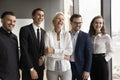 Joyful colleagues and happy elder team leader woman standing together Royalty Free Stock Photo