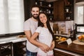 Couple hugging in the kitchen at home in the morning Royalty Free Stock Photo